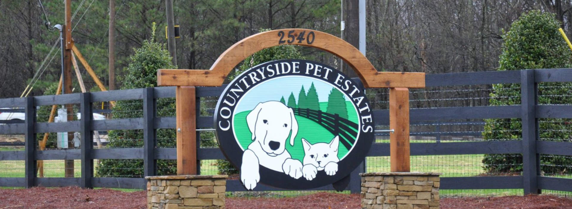 Countryside Pet Estates banner installed on a fence